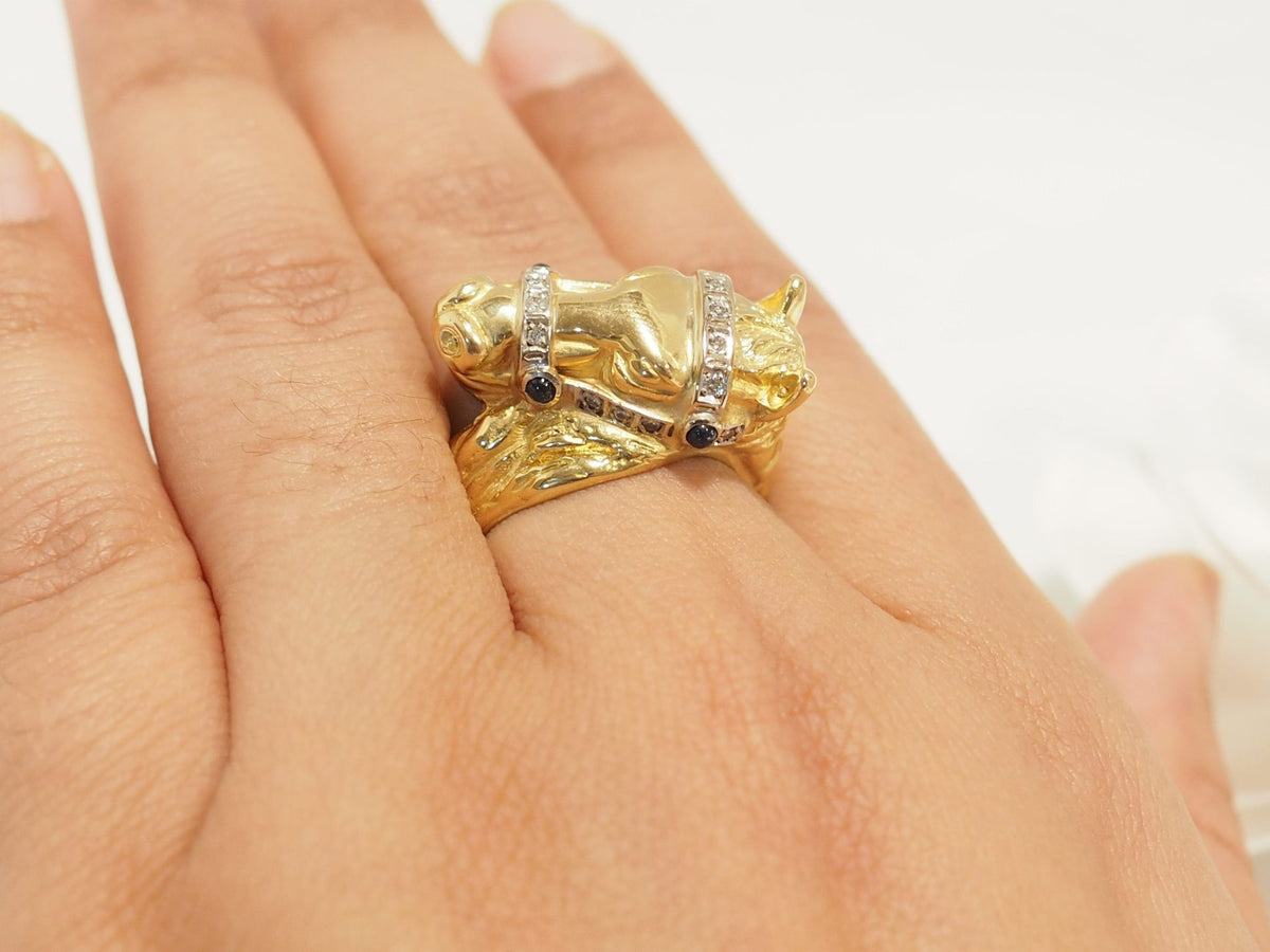 Bague L'Aurore en forme de tête de cheval en or jaune 18 carats ornée de diamants et de saphirs portée au doigt