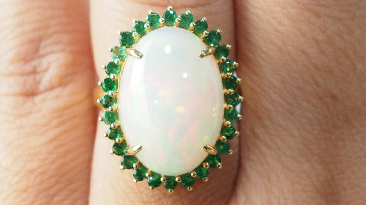 Bague ovale en or jaune, opale cabochon et émeraudes