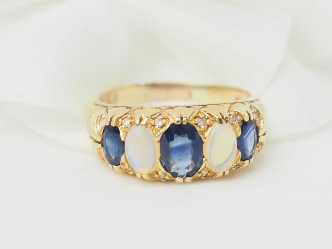 Bague jarretière en or jaune, saphirs et pierres de lune