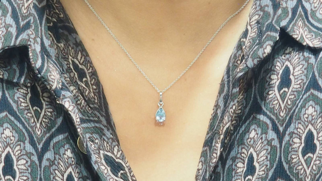Collier solitaire en or blanc et topaze bleue