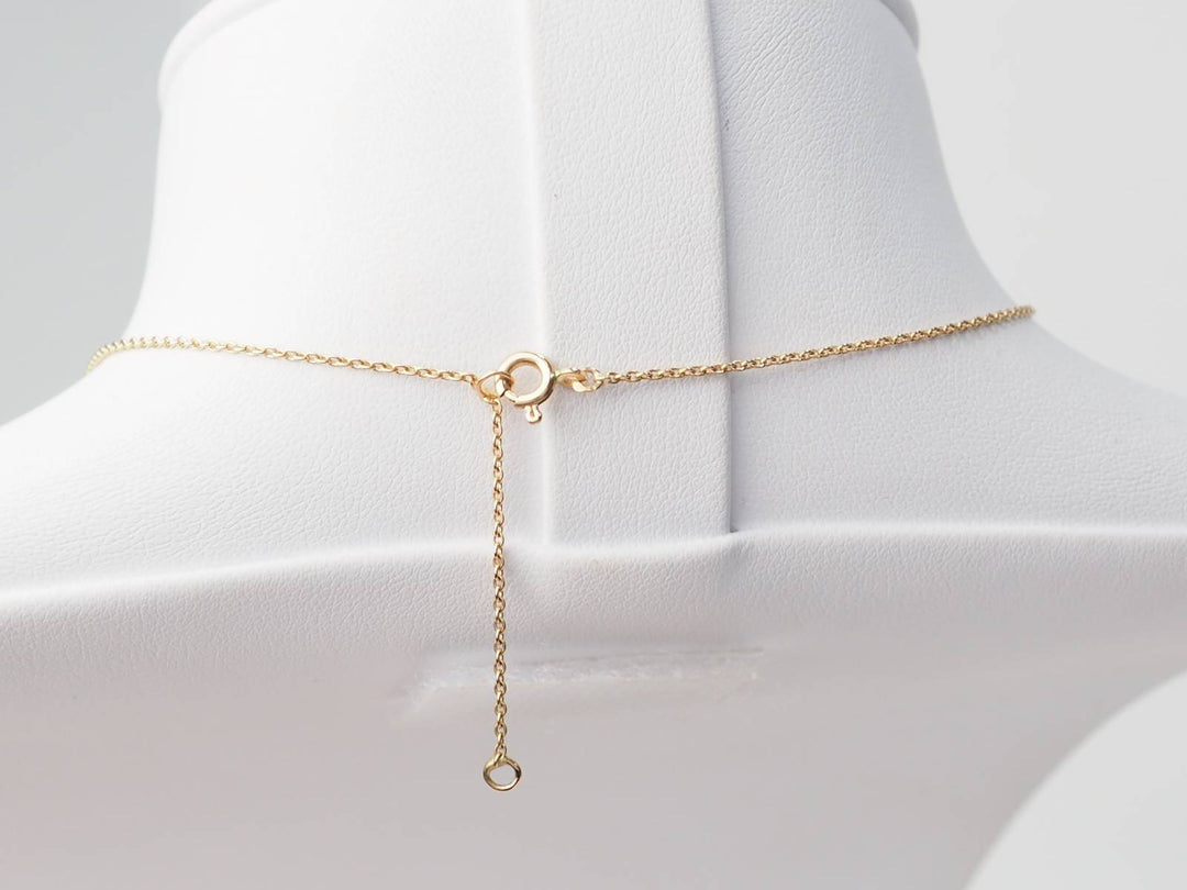 Collier volutes en or jaune et argent, grenat diamants et perle