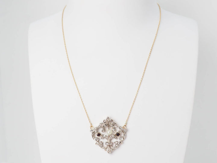 Collier volutes en or jaune sertis de diamants et grenats
