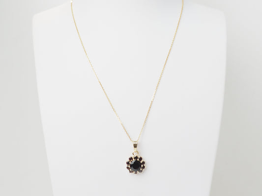 Collier pendentif marguerite en or jaune et grenats