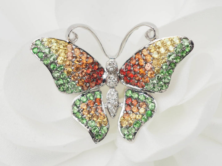 Broche papillon en or blanc, citrine, topaze et péridot