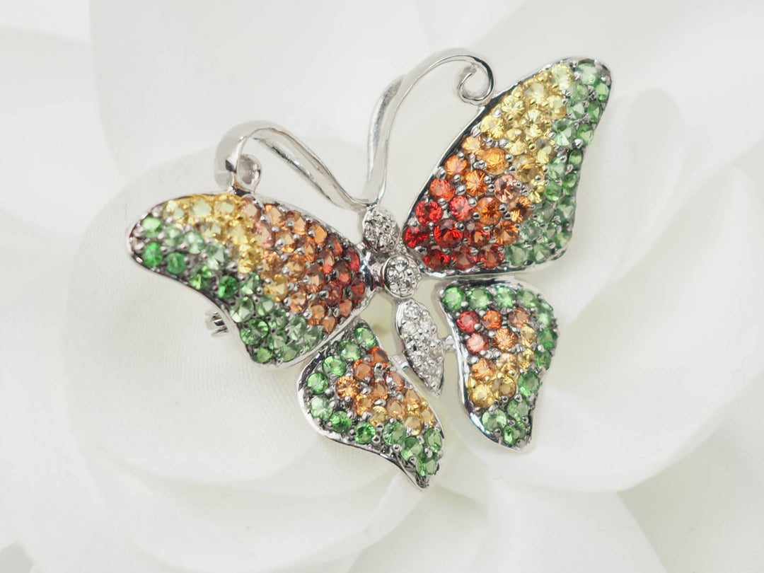 Broche papillon en or blanc, citrine, topaze et péridot