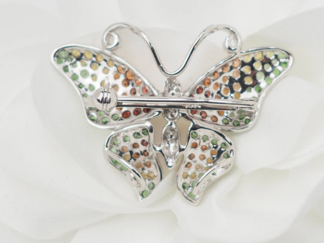 Broche papillon en or blanc, citrine, topaze et péridot