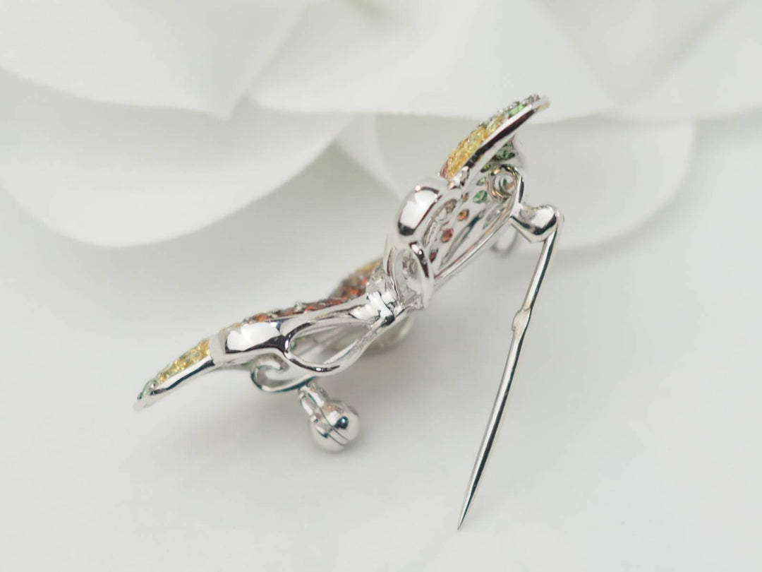 Broche papillon en or blanc, citrine, topaze et péridot