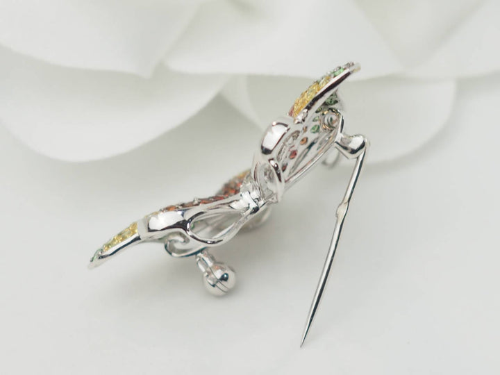Broche papillon en or blanc, citrine, topaze et péridot