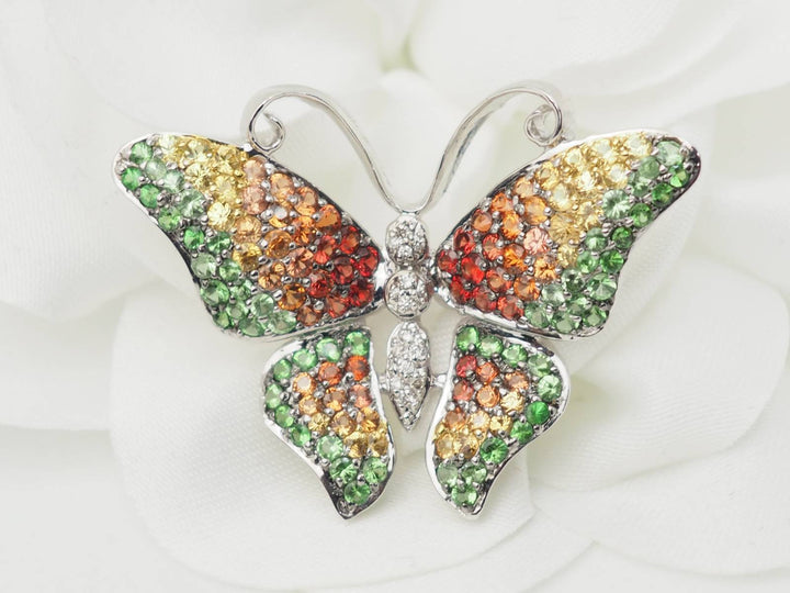 Broche papillon en or blanc, citrine, topaze et péridot