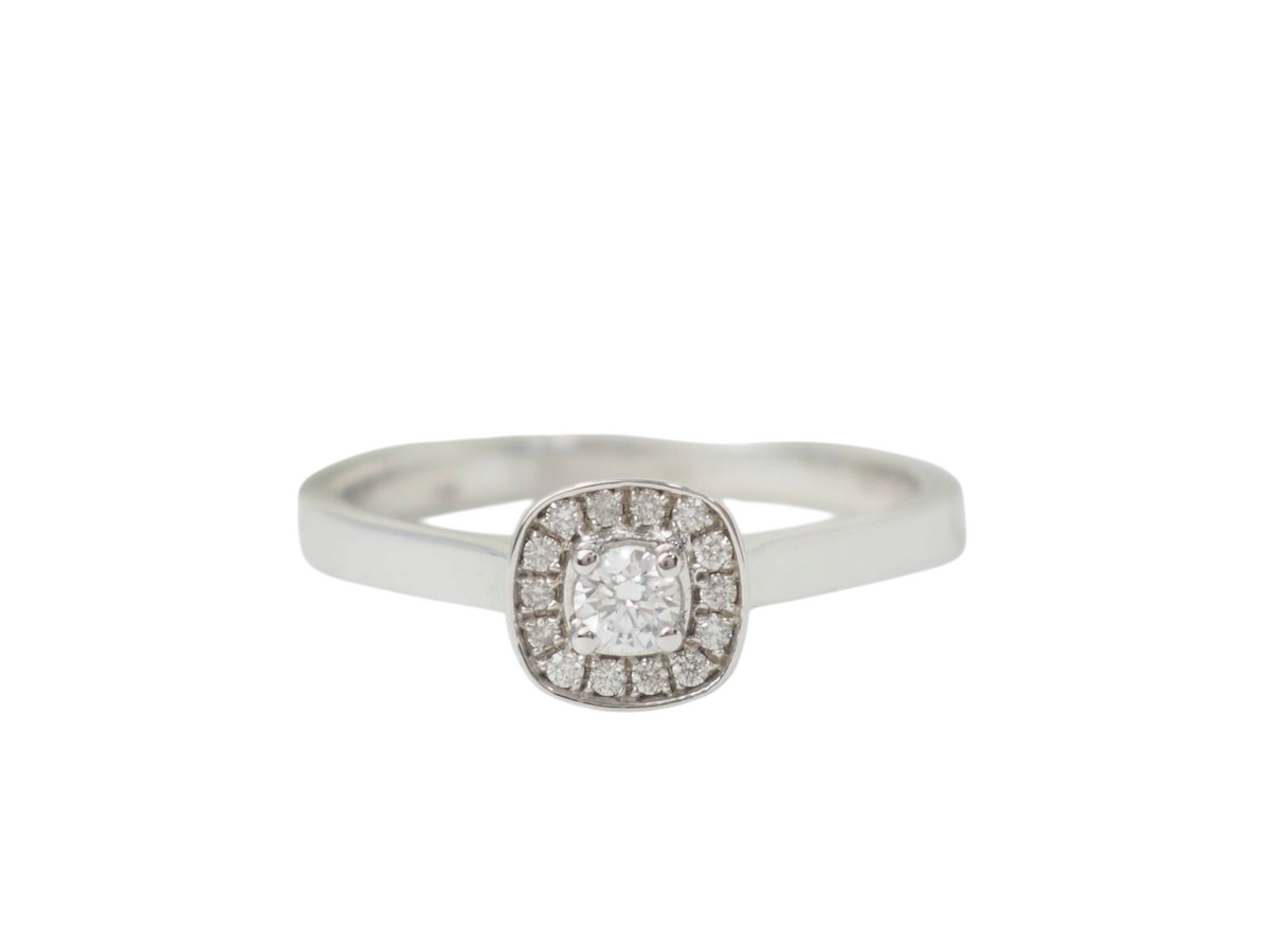 Bague solitaire L'Aurore en or blanc 18 carats avec diamant central de 0,15 carat et entourage de petits diamants