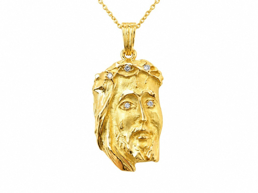 Pendentif L'Aurore visage du Christ en métal doré avec détails sculptés et pierres scintillantes sur chaîne fine