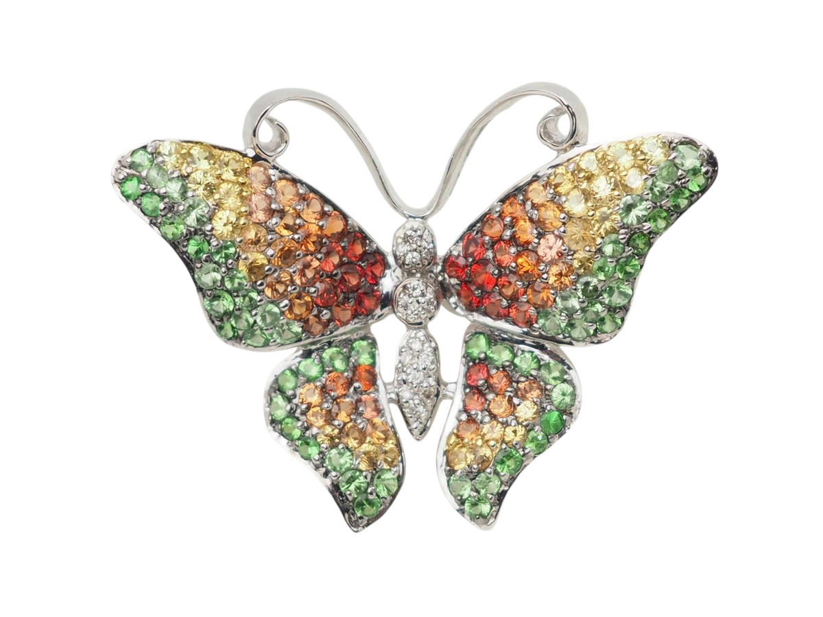 Broche papillon L'Aurore en or blanc 18kt, sertie de diamants, péridots, citrines et topazes multicolores.