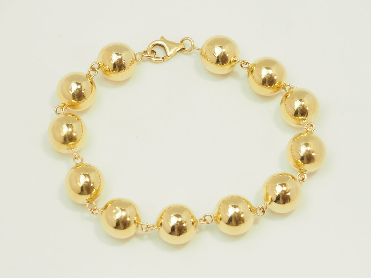 Bracelet marseillais L'Aurore en or jaune 18 carats composé de boules polies de 12 mm avec fermoir mousqueton
