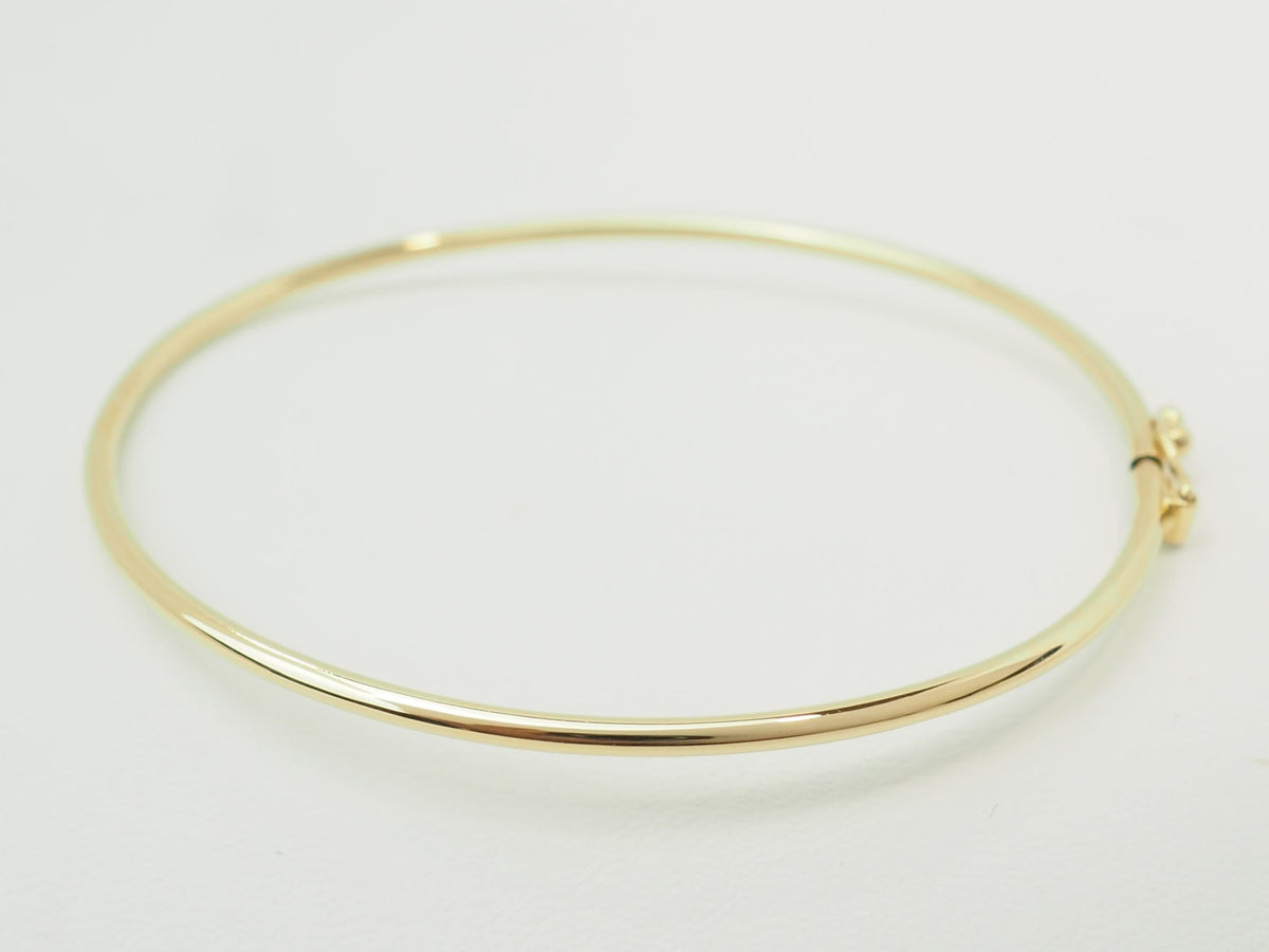 Bracelet jonc flexible L'Aurore en or jaune 18 carats avec fermoir de sécurité, design fin et élégant